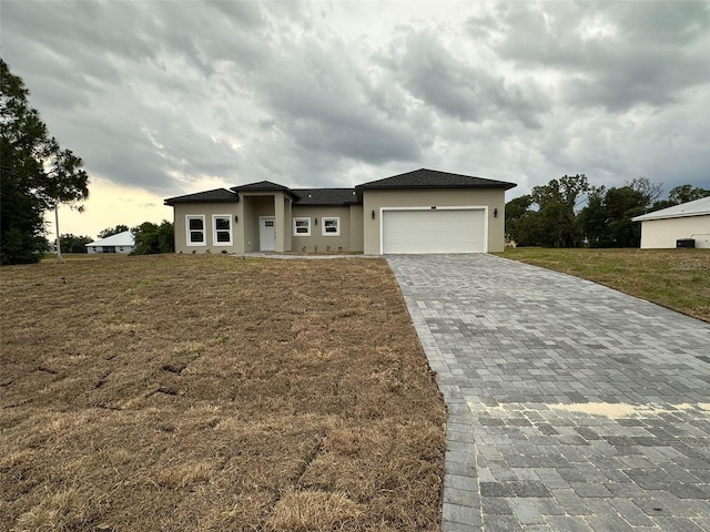 7908 Pine Glen Rd, Sebring, FL 33876 - prairie-style house featuring decorative driveway, stucco siding, a garage, and a front yard