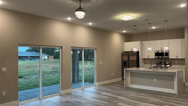 7908 Pine Glen Rd, Sebring, FL 33876 - kitchen featuring stainless steel appliances, light wood-style floors, white cabinets, light countertops, and plenty of natural light