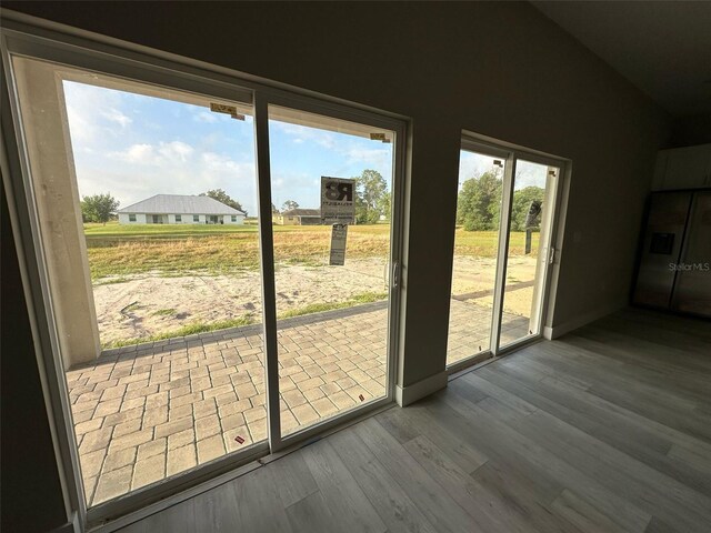 7908 Pine Glen Rd, Sebring, FL 33876 - doorway featuring wood finished floors and lofted ceiling