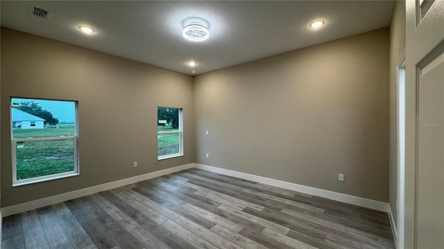 7908 Pine Glen Rd, Sebring, FL 33876 - spare room featuring wood finished floors and recessed lighting