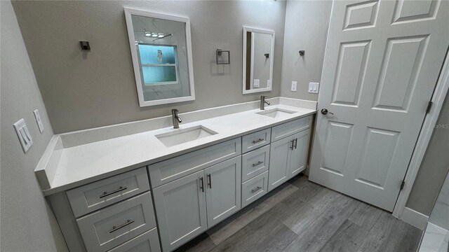7908 Pine Glen Rd, Sebring, FL 33876 - bathroom with double vanity and wood finished floors