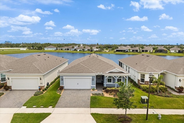 ranch-style house featuring a front yard, a garage, decorative driveway, and a residential view