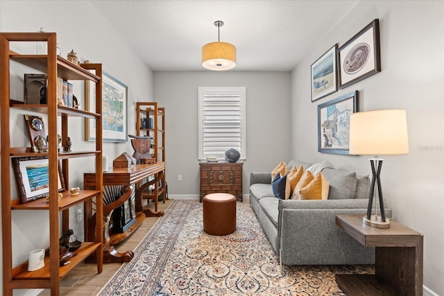 sitting room with light wood-type flooring and baseboards