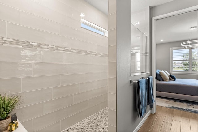 full bathroom with ensuite bath, wood finished floors, and a walk in shower