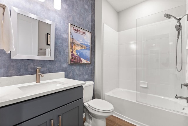 bathroom with toilet, vanity, shower / washtub combination, and wood finished floors