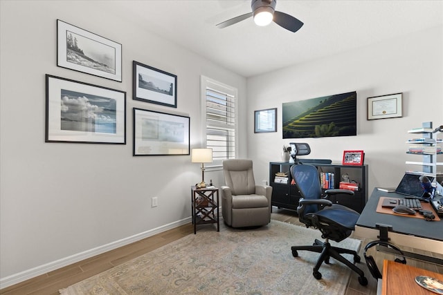 office area with ceiling fan, baseboards, and wood finished floors