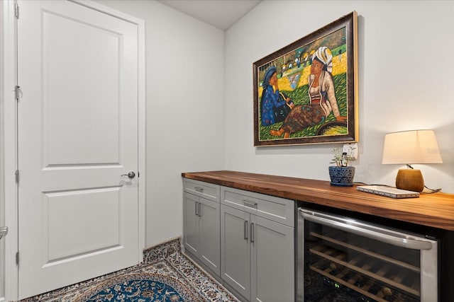 bar with wine cooler and a bar