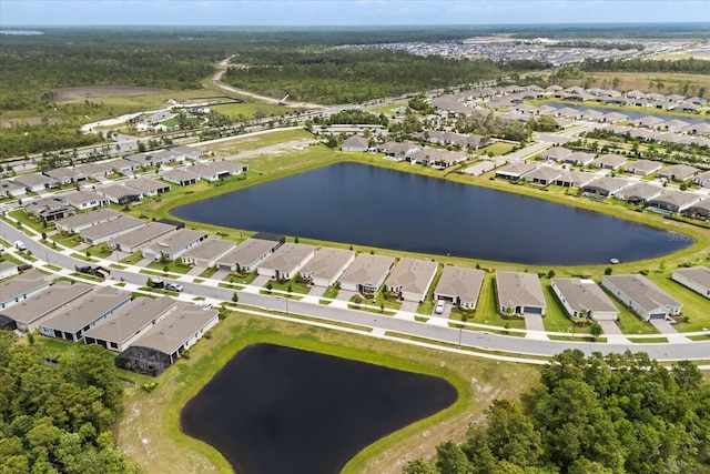 birds eye view of property with a water view and a residential view