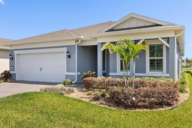 ranch-style home featuring driveway, stucco siding, an attached garage, and a front yard