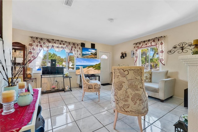 living area featuring light tile patterned flooring and visible vents