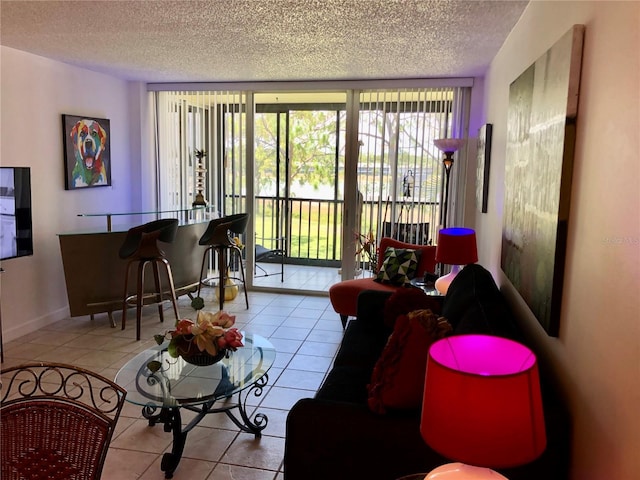 25806 Cockleshell Dr Unit 314, Bonita Springs, FL 34135 - living room with tile patterned floors, a textured ceiling, and expansive windows