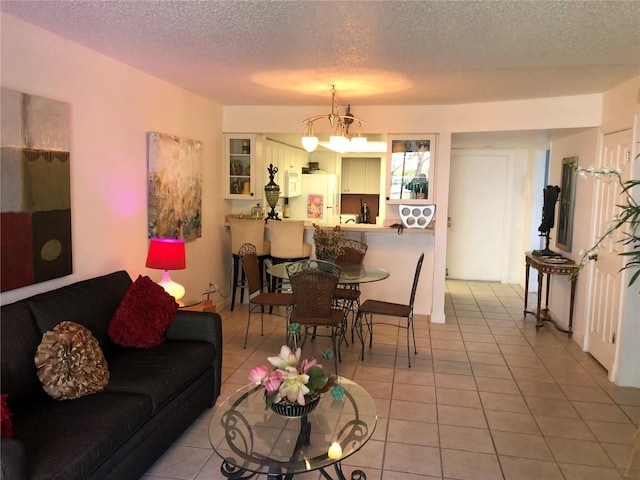 25806 Cockleshell Dr Unit 314, Bonita Springs, FL 34135 - living area featuring light tile patterned floors and a textured ceiling