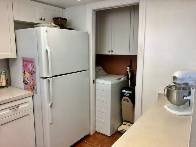 25806 Cockleshell Dr Unit 314, Bonita Springs, FL 34135 - interior space featuring freestanding refrigerator, washer / clothes dryer, tile patterned floors, light countertops, and white cabinets