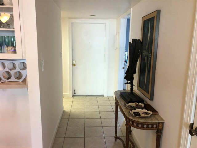 25806 Cockleshell Dr Unit 314, Bonita Springs, FL 34135 - hall with baseboards and tile patterned flooring