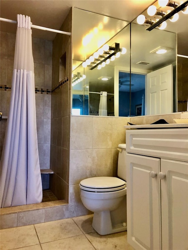 25806 Cockleshell Dr Unit 314, Bonita Springs, FL 34135 - full bathroom with toilet, tiled shower, tile patterned floors, tile walls, and vanity