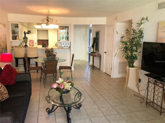 25806 Cockleshell Dr Unit 314, Bonita Springs, FL 34135 - living area with light tile patterned floors, visible vents, and a textured ceiling