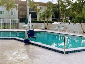 25806 Cockleshell Dr Unit 314, Bonita Springs, FL 34135 - community pool with fence and a patio area