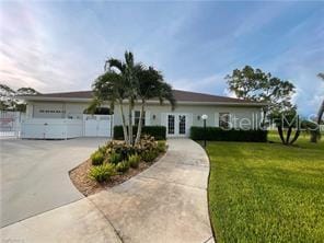 25806 Cockleshell Dr Unit 314, Bonita Springs, FL 34135 - single story home featuring driveway, a front lawn, french doors, and a garage