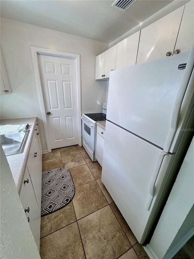 kitchen with white cabinetry, a sink, white appliances, and light countertops