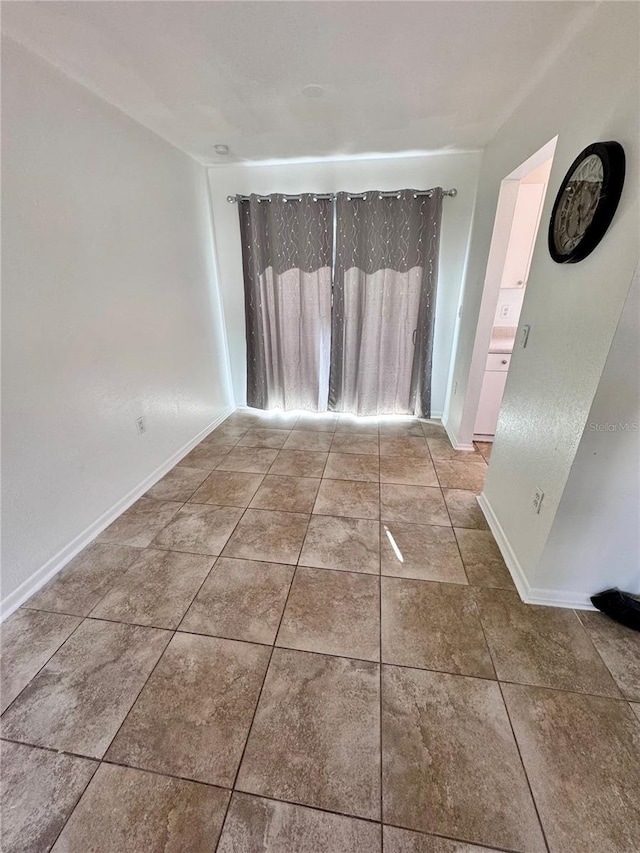 interior space featuring baseboards and tile patterned floors