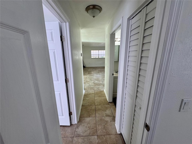 hall with tile patterned flooring