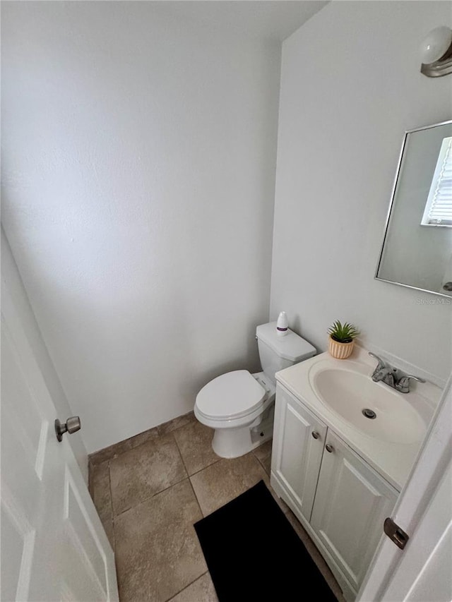 bathroom featuring toilet, vanity, and tile patterned floors