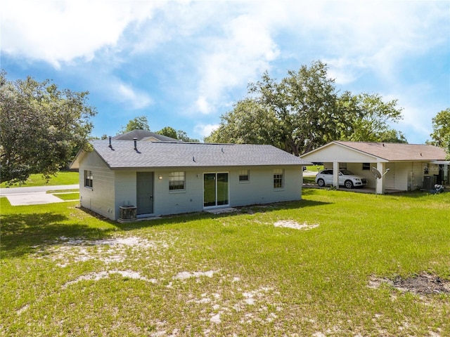 14796 SW 39th Cir, Ocala, FL 34473 - back of house with a lawn, roof with shingles, and a carport