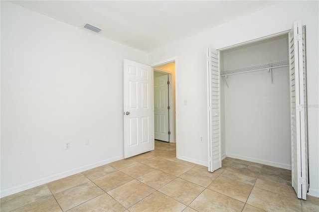 14796 SW 39th Cir, Ocala, FL 34473 - unfurnished bedroom featuring a closet and light tile patterned flooring