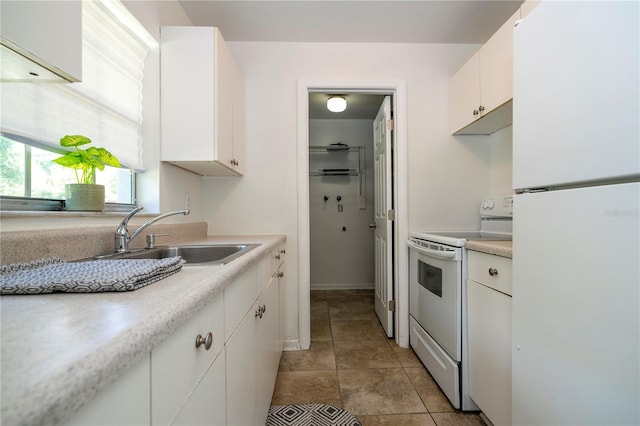 14796 SW 39th Cir, Ocala, FL 34473 - kitchen featuring white appliances, white cabinetry, light countertops, and light tile patterned floors