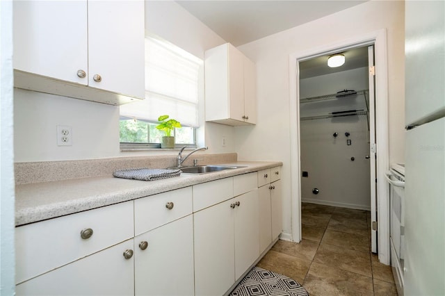 14796 SW 39th Cir, Ocala, FL 34473 - kitchen with white cabinets, light countertops, and fridge