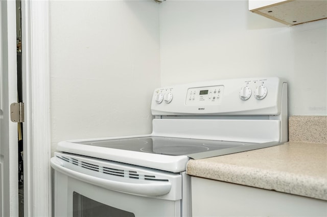14796 SW 39th Cir, Ocala, FL 34473 - kitchen featuring white range with electric stovetop, range hood, and light countertops