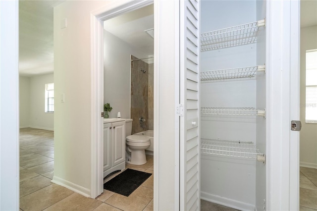 14796 SW 39th Cir, Ocala, FL 34473 - full bathroom featuring tile patterned flooring, vanity, shower / bath combination, and a walk in closet