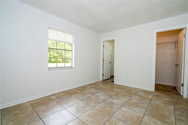 14796 SW 39th Cir, Ocala, FL 34473 - unfurnished bedroom featuring a spacious closet, a closet, and light tile patterned flooring
