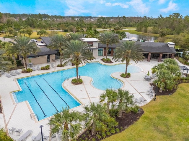 pool featuring a water view and a patio