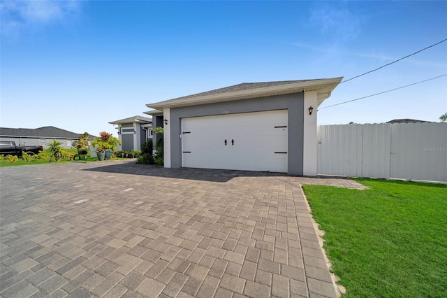 1214 Embers Pkwy W, Cape Coral, FL 33993 - garage featuring fence and decorative driveway