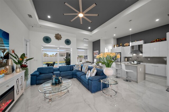 1214 Embers Pkwy W, Cape Coral, FL 33993 - living area with a towering ceiling, visible vents, ceiling fan, and a raised ceiling