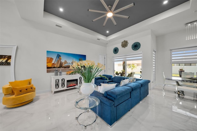 1214 Embers Pkwy W, Cape Coral, FL 33993 - living area with a towering ceiling, a ceiling fan, visible vents, marble finish floor, and a raised ceiling