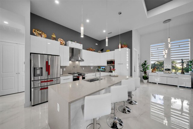 1214 Embers Pkwy W, Cape Coral, FL 33993 - kitchen featuring white cabinets, a sink, wall chimney range hood, stainless steel appliances, and marble finish floor