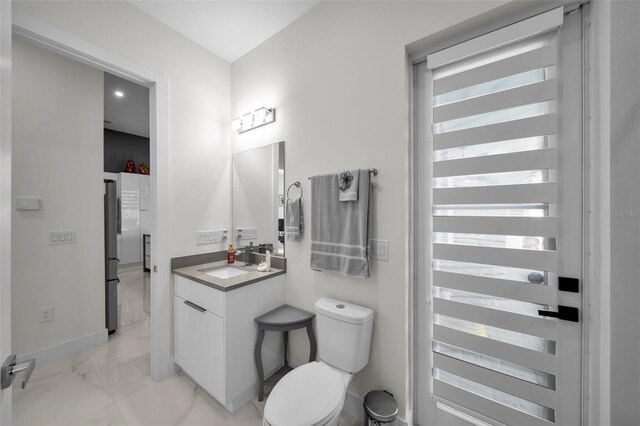 1214 Embers Pkwy W, Cape Coral, FL 33993 - bathroom featuring vanity, marble finish floor, baseboards, and toilet