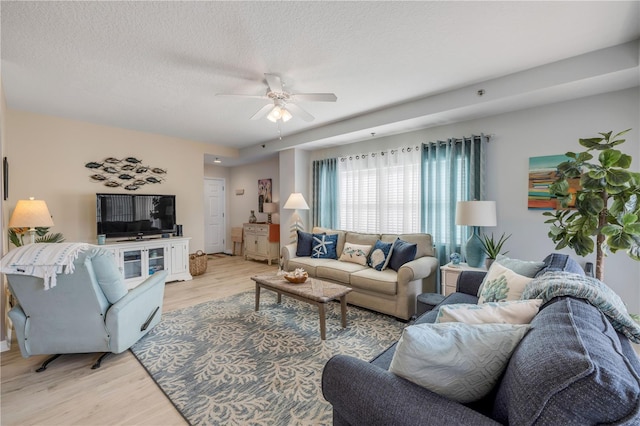 5300 S Atlantic Ave Unit 2-501, New Smyrna Beach, FL 32169 - living area with light wood-style flooring, a textured ceiling, and ceiling fan