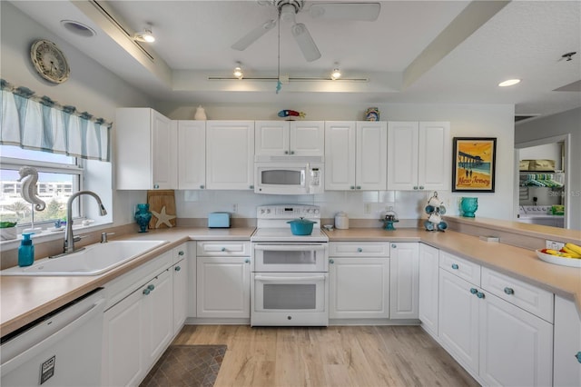 5300 S Atlantic Ave Unit 2-501, New Smyrna Beach, FL 32169 - kitchen featuring white appliances, light wood-style flooring, white cabinetry, and a sink