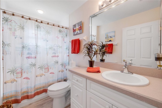 5300 S Atlantic Ave Unit 2-501, New Smyrna Beach, FL 32169 - bathroom with vanity, toilet, and wood finished floors