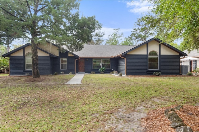 view of front of house with a front lawn, central air condition unit, and roof with shingles