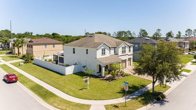 3556 Cheswick Dr, Ocoee, FL 34761 - view of front facade featuring a residential view, a garage, fence, and a front lawn