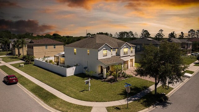 3556 Cheswick Dr, Ocoee, FL 34761 - view of front of property featuring a residential view, stucco siding, an attached garage, a front lawn, and fence