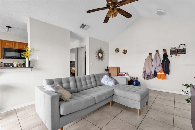 1065 S Hiawassee Rd Unit 1436, Orlando, FL 32835 - living room with ceiling fan, visible vents, light tile patterned floors, baseboards, and high vaulted ceiling