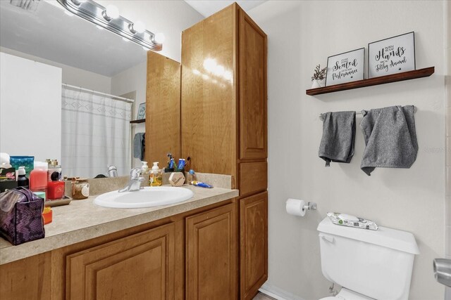 1065 S Hiawassee Rd Unit 1436, Orlando, FL 32835 - full bathroom with toilet, a shower with curtain, and vanity