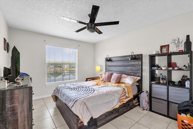 1065 S Hiawassee Rd Unit 1436, Orlando, FL 32835 - bedroom with light tile patterned floors, a ceiling fan, and a textured ceiling
