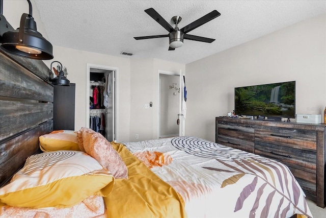 1065 S Hiawassee Rd Unit 1436, Orlando, FL 32835 - bedroom with ceiling fan, a textured ceiling, visible vents, a closet, and a spacious closet