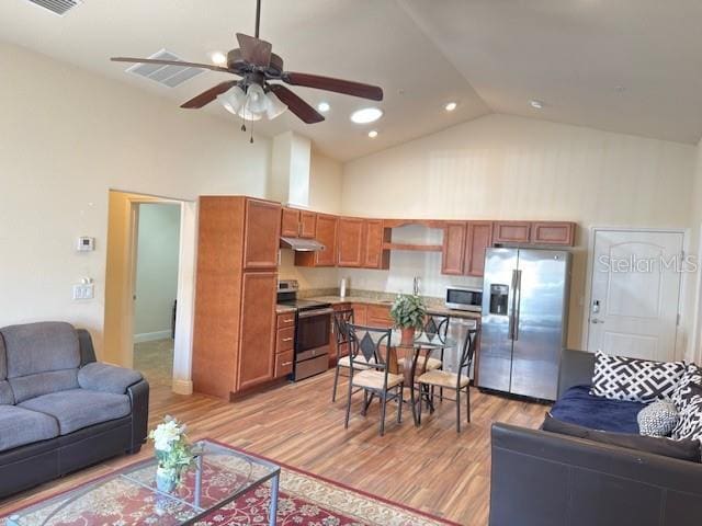 living area featuring ceiling fan, high vaulted ceiling, recessed lighting, light wood-type flooring, and visible vents